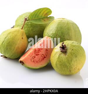 Fresh sliced guava and leaves (jambu biji merah) or Psidium guajava, isolated on white. Can enhance Body Immunity, Lower Blood Pressure and Cholestero Stock Photo