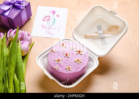 https://l450v.alamy.com/450v/2hpkxgh/plastic-lunch-box-with-tasty-bento-cake-greeting-card-and-flowers-on-color-background-2hpkxgh.jpg