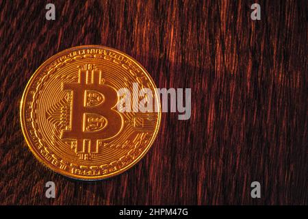Bitcoin coin on a dark wooden background Stock Photo