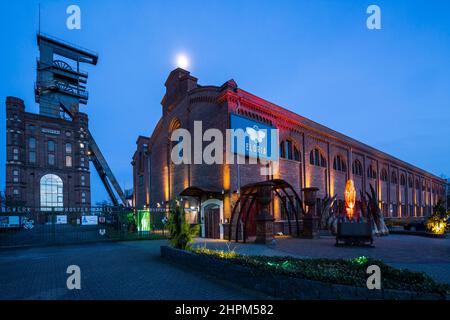 Germany, Bottrop, Ruhr area, Westphalia, North Rhine-Westphalia, NRW, Route of Industrial Heritage, hard coal mining industry, coalmine Prosper-Haniel, shaft tower Prosper II, Malakoff tower with headframe and former pithead bath, nowadays FLORIA adventure factory and catering trade, night photograph Stock Photo