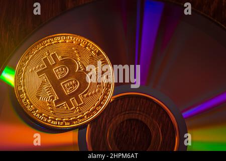 Bitcoin coin on a CD - DVD, background for design Stock Photo