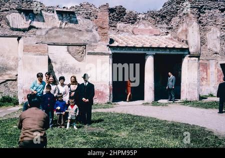 Archive scan of ruins of Pompeii commune destroyed by eruption of Mount Vesuvius in AD 79. Tourists in front of the Stabian Baths palestra. Archival scan from a slide. August 1968. Stock Photo