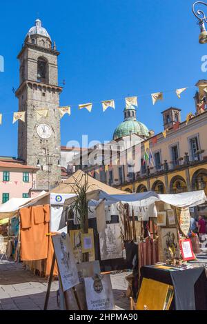 Pontremoli, Italy Piazza della Republic; famous bell tower and green dome of the Saint Maria Del Popolòs Cathedral and market stalls. Stock Photo