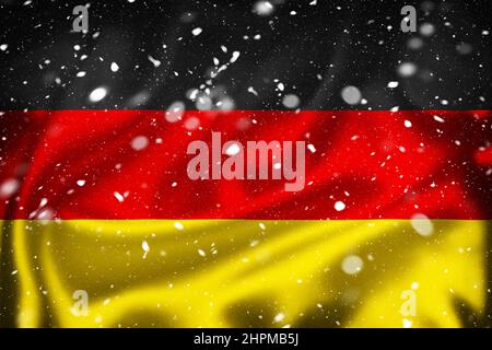 German silk surface flag and snow layer, country symbol concept of Germany Stock Photo