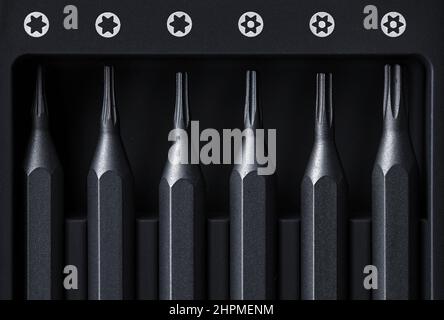 Screwdriver tips different shapes and sizes close up. Manual metal mini screwdriver and set of the interchangeable bits. Precision Screwdriver Kit. St Stock Photo