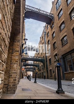 Shad Thames, London. Low, wide angle view of the Victorian architecture of the former industrial area now a gentrified shopping and business district. Stock Photo