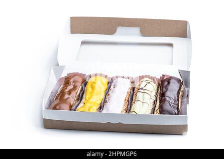 Set of  decorated eclairs in paper box isolated on white Stock Photo