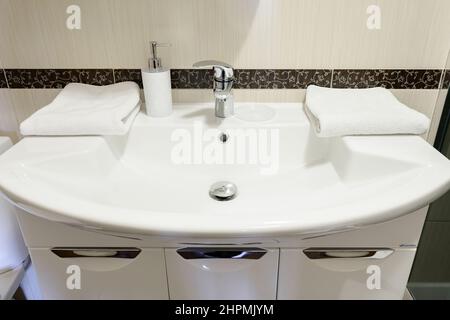 Bukovel, Ukraine February 4, 2022: washbasin close-up in the bathroom and room, a simple white washbasin. Stock Photo