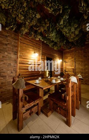 Bukovel, Ukraine February 4, 2022: bath in the Bukovel Hotel, steam treatments, wooden sunbeds and birch brooms. Stock Photo