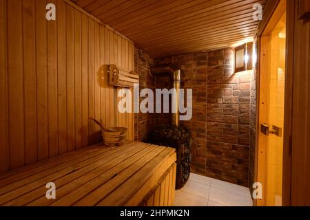 Bukovel, Ukraine February 4, 2022: bath in the Bukovel Hotel, steam treatments, wooden sunbeds and birch brooms. Stock Photo