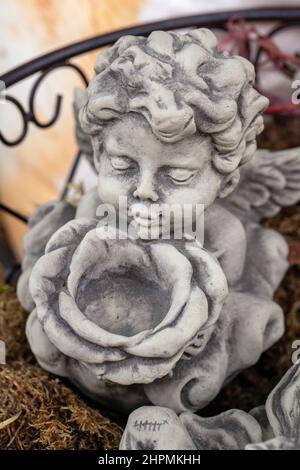 Small angel figurine with flower pot Stock Photo