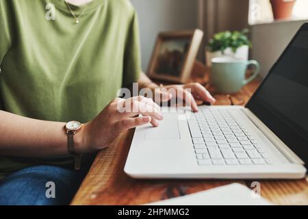 An entrepreneurs job is never over. Cropped shot of an unrecognizable businesswoman sitting alone in her home office and typing on her laptop. Stock Photo