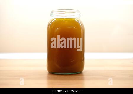 jar of beef bone broth on wooden kitchen toable top Stock Photo