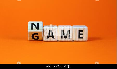 Name of the game symbol. Wooden blocks with concept words Name Game. Beautiful orange table orange background. Business and name of the game concept. Stock Photo