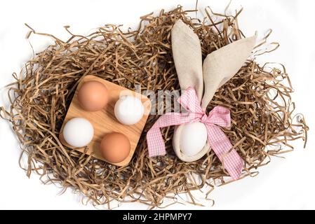 Easter natural eggs in a wooden bowl and rabbit ears from a linen napkin Stock Photo