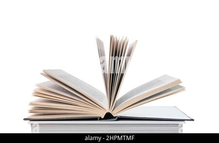 Open book lying at books stack isolated on white background. Reading and turning pages. Education and intellectual development concept. High quality photo Stock Photo