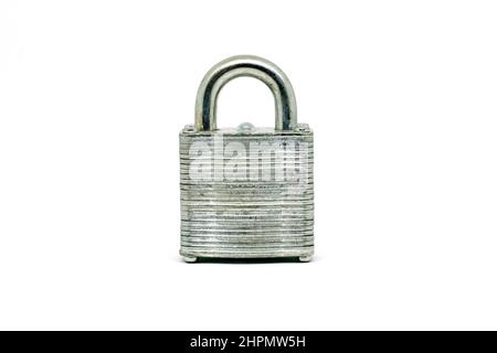Close up of a silver coloured metal padlock, closed, isolated against a white background. Stock Photo