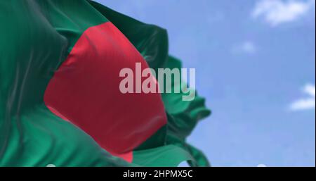 Detail of the national flag of Bangladesh waving in the wind on a clear day. is a country in South Asia. It is the eighth-most populous country in the Stock Photo