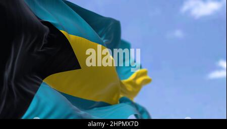 Detail of the national flag of the Bahamas waving in the wind on a clear day. Bahamas is a sovereign country within the Lucayan Archipelago of the Wes Stock Photo