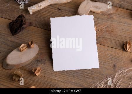 Blank stationery card mockup with torn edges for wedding mockup invitation on a wooden rustic retro background with boho decoration. Bohemian wedding Stock Photo