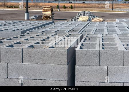 Horizontal shot of cinder blocks with a pile of broken ones in the background. Stock Photo