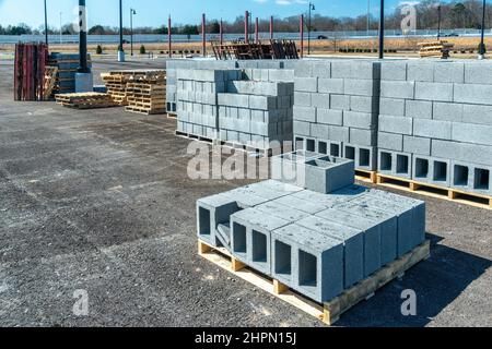 Horizontal shot of pallets of new cinder blocks at an industrial construction site. Stock Photo