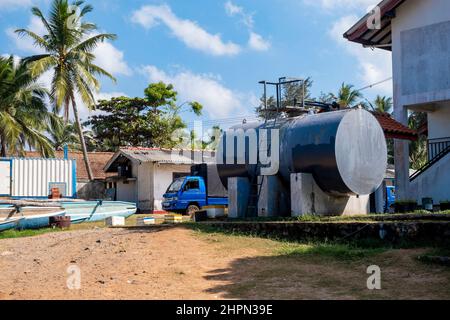 water tank in tropical country with a car Stock Photo