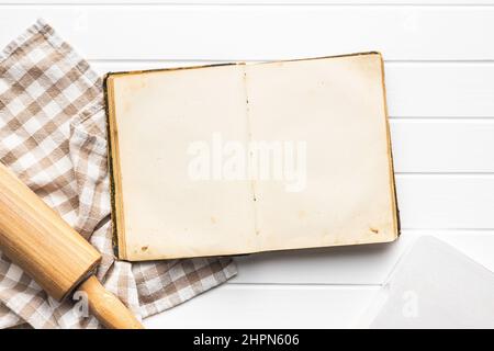 Open blank cookbook. Antique recipe book on white table. Top view. Stock Photo