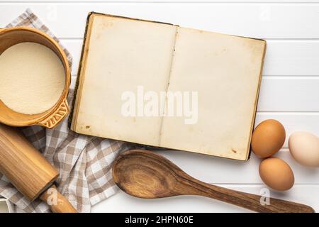 Open blank cookbook. Antique recipe book on white table. Top view. Stock Photo