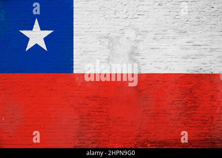 Full frame photo of a weathered flag of Chile painted on a plastered brick wall. Stock Photo