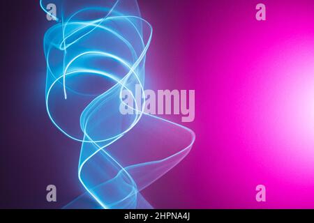 Neon abstract led lines on a magenta background. Fluorescent vaporwave wallpaper. Stock Photo
