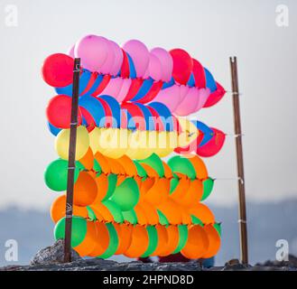 Colorful balloons wall for party and carnival. many colored balloons forming a bright background wallpaper image. Stock Photo
