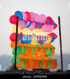 Colorful balloons wall for party and carnival. many colored balloons forming a bright background wallpaper image. Stock Photo