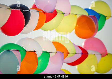 Colorful balloons wall for party and carnival. many colored balloons forming a bright background wallpaper image. Stock Photo