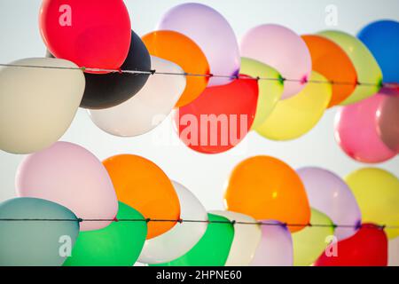 Colorful balloons wall for party and carnival. many colored balloons forming a bright background wallpaper image. Stock Photo