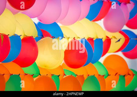 Colorful balloons wall for party and carnival. many colored balloons forming a bright background wallpaper image. Stock Photo