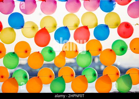Colorful balloons wall for party and carnival. many colored balloons forming a bright background wallpaper image. Stock Photo