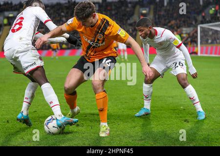 Kingston Upon Hull, UK. 22nd Feb, 2022. Hull City's Ryan Longman (16) nutmegs Barnsley's Domingos Quina as Remy Vita (26) looks on during the EFL Sky Bet Championship match between Hull City and Barnsley at the KCOM Stadium, Kingston upon Hull, England on 22 February 2022. Photo by Simon Hall. Editorial use only, license required for commercial use. No use in betting, games or a single club/league/player publications. Credit: UK Sports Pics Ltd/Alamy Live News Stock Photo