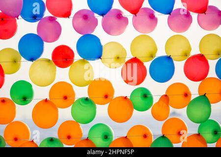 Colorful balloons wall for party and carnival. many colored balloons forming a bright background wallpaper image. Stock Photo