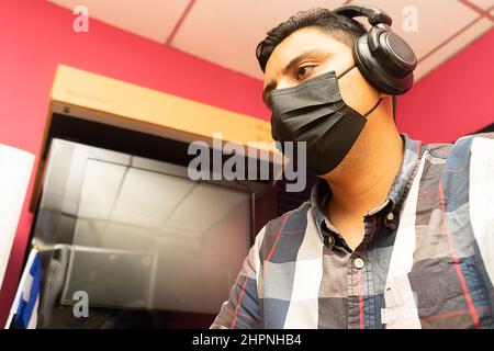 Latino man working with his covid 19 mask on correctly Stock Photo