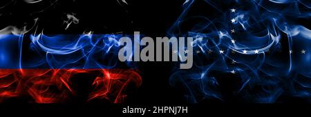 Donetsk People's Republic vs Naval Jack Brazil flag. Smoke flags placed side by side isolated on black background. Stock Photo
