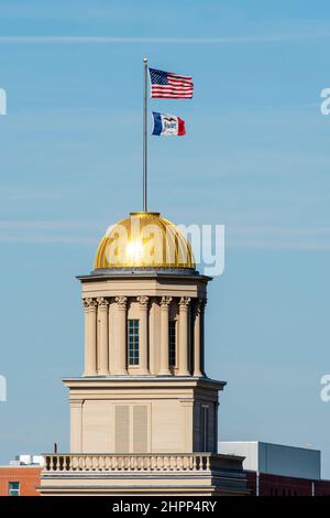 Photograph of the Old Capitol building dome and flags on a windy day. University of Iowa, Iowa City, Iowa, USA. Stock Photo