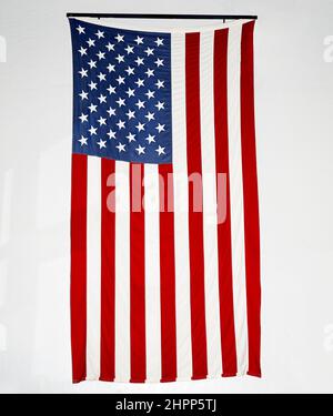 Large American Flag hanging on Wall Stock Photo