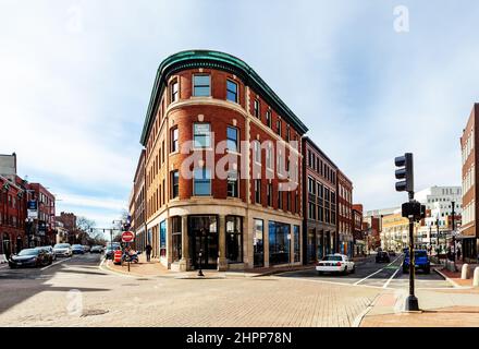 Cambridge, Massachusetts, USA - February 19, 2022: Harvard Square, intersection of JFK Street and Brattle Street, featuring the Abbot building. Stock Photo