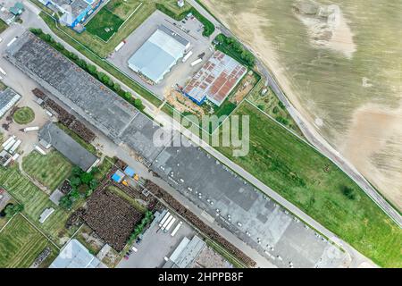 group of large industrial warehouses or factory buildings in suburban city area. drone photo. Stock Photo