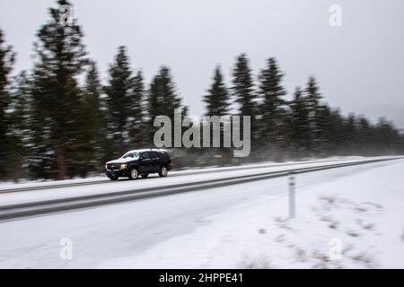 Reno, United States. 22nd Feb, 2022. A car with snow on the roof drives in winter conditions. Winter road conditions worsen as snow falls in the mountains. Chains where required on all vehicles except 4-Wheel drive with snow tires. Credit: SOPA Images Limited/Alamy Live News Stock Photo