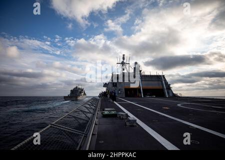 220219-N-LI768-1034  SOUTH CHINA SEA (Feb. 19, 2022) – The Independence-variant littoral combat ship USS Tulsa (LCS 16) approaches the dry cargo ship USNS Amelia Earhart (T-AKE 6) for a replenishment-at-sea. Tulsa, part of Destroyer Squadron (DESRON) 7, is on a rotational deployment, operating in the U.S. 7th Fleet area of operations to enhance interoperability with partners and serve as a ready-response force in support of a free and open Indo-Pacific region. (U.S. Navy photo by Mass Communication Specialist 1st Class Devin M. Langer) Stock Photo