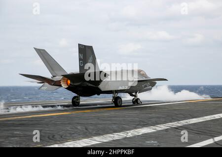 PHILIPPINE SEA (Feb. 22, 2022) An F-35C Lightning II, assigned to the 'Black Knights' of Marine Fighter Attack Squadron (VMFA) 314, launches from the flight deck of the Nimitz-class aircraft carrier USS Abraham Lincoln (CVN 72). Abraham Lincoln Strike Group is on a scheduled deployment in the U.S. 7th Fleet area of operations to enhance interoperability through alliances and partnerships while serving as a ready-response force in support of a free and open Indo-Pacific region. (U.S. Navy photo by Mass Communication Specialist 3rd Class Michael Singley) Stock Photo