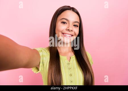 Photo of blogger little lady hold camera take selfie portrait wear green top isolated pink color background Stock Photo