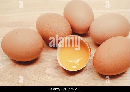 Broken egg with many eggs and yolk visible. Stock Photo